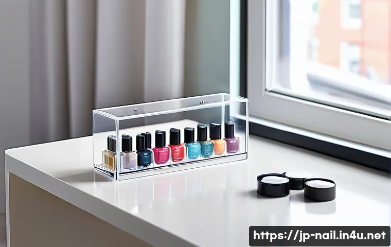 네일 폴리시 보존 용기 추천 - A stylish, modern nail polish storage setup featuring a transparent UV-cut storage case with multipl...